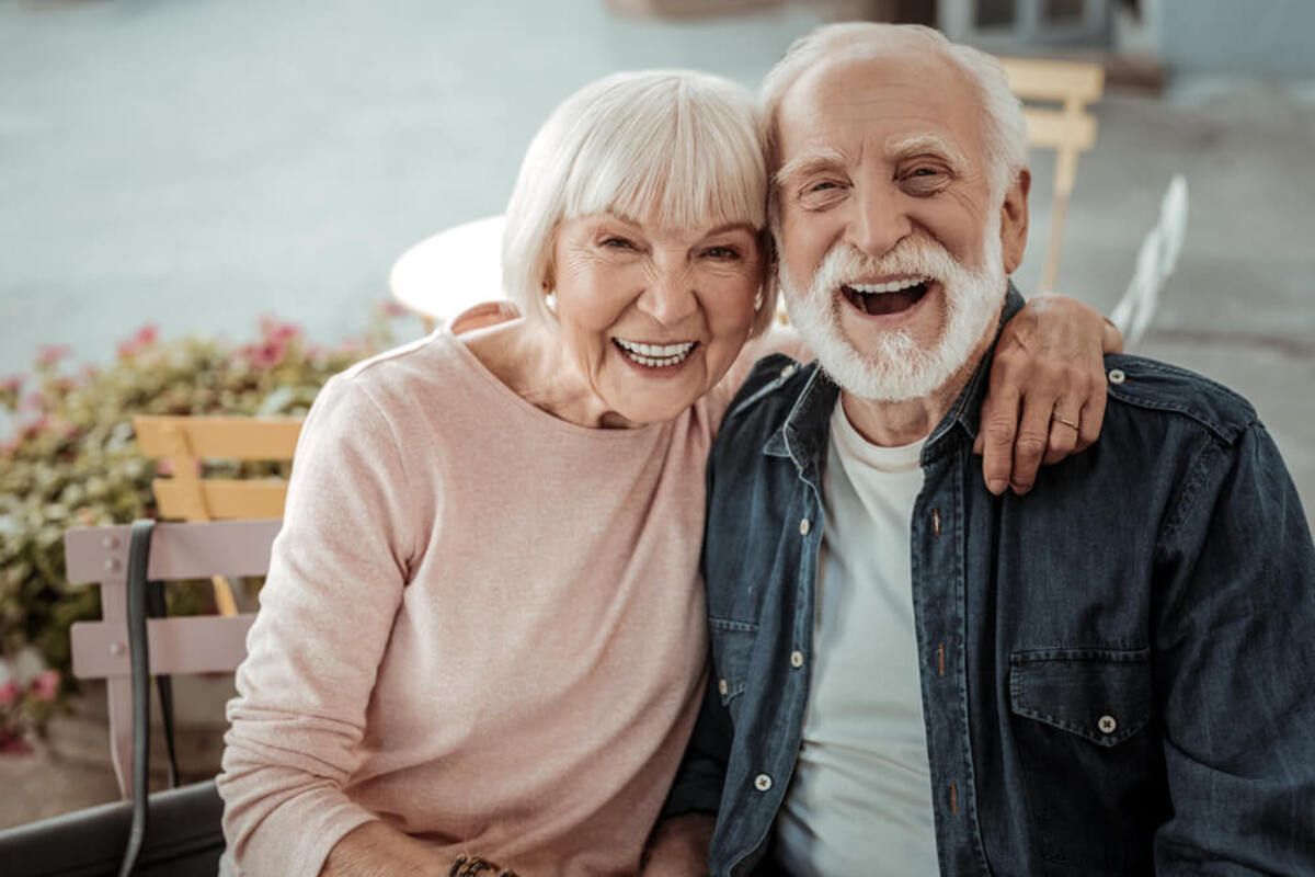 A Smiling Couple With White Hair and Casual Clothing — Killara Dental in East Killara, NSW