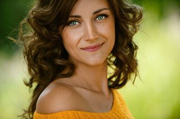 A Woman With Curly Brown Hair and a Yellow — Killara Dental in East Killara, NSW