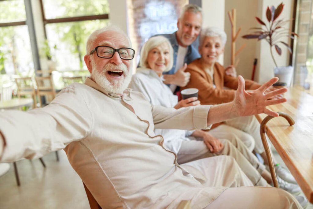 Four People Smiling and Laughing at a Table in a Bright Room — Killara Dental in East Killara, NSW