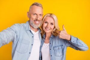 A Smiling Couple Wearing Denim Shirts — Killara Dental in East Killara, NSW