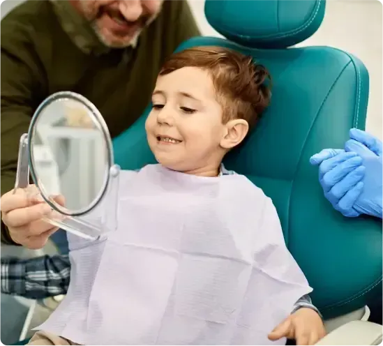 Smiling Child Sits in a Dental Chair — Killara Dental in East Killara, NSW
