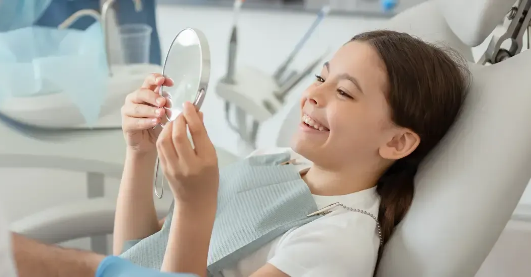 Person in a Dental Chair Looks Into a Small Hand Mirror — Killara Dental in East Killara, NSW