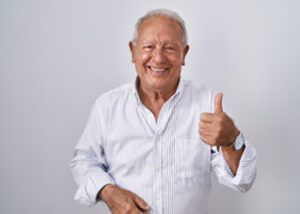 Smiling Person in a Light, Button-down Striped Shirt Giving a Thumbs-up — Killara Dental in East Killara, NSW