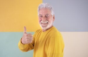 Smiling Person in a Yellow Shirt Giving a Thumbs Up — Killara Dental in East Killara, NSW