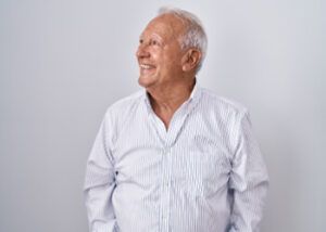 An Individual Wearing a Button-down Shirt Smiles and Looks Toward the Upper Left — Killara Dental in East Killara, NSW