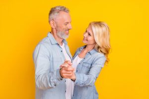 A Man and Woman in Denim Shirts Smiling at Each Other — Killara Dental in East Killara, NSW