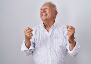 A Person Wearing a White, Vertically Striped Button-down Shirt Looks Upward — Killara Dental in East Killara, NSW