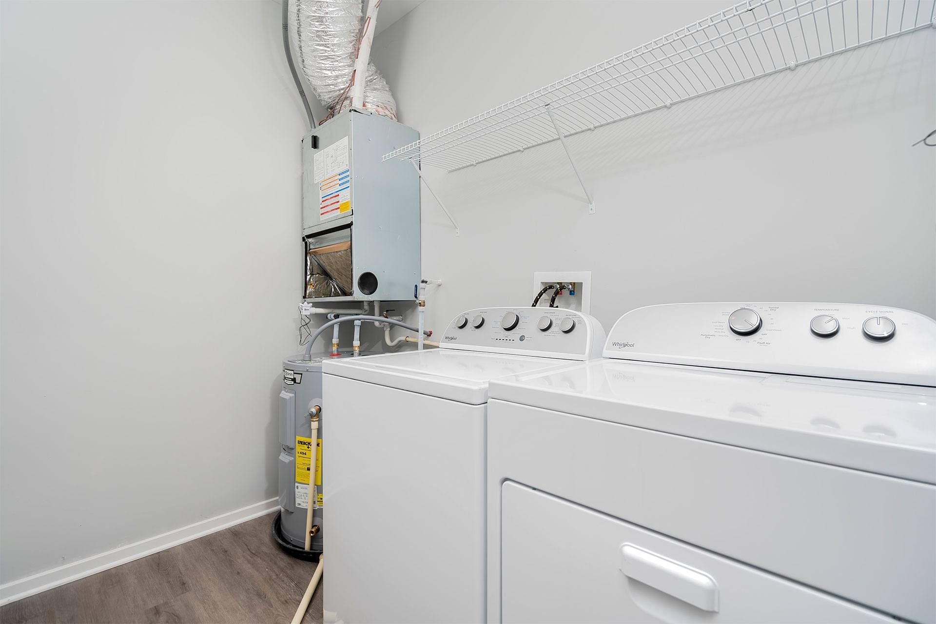 A white dryer and washer in a laundry room.