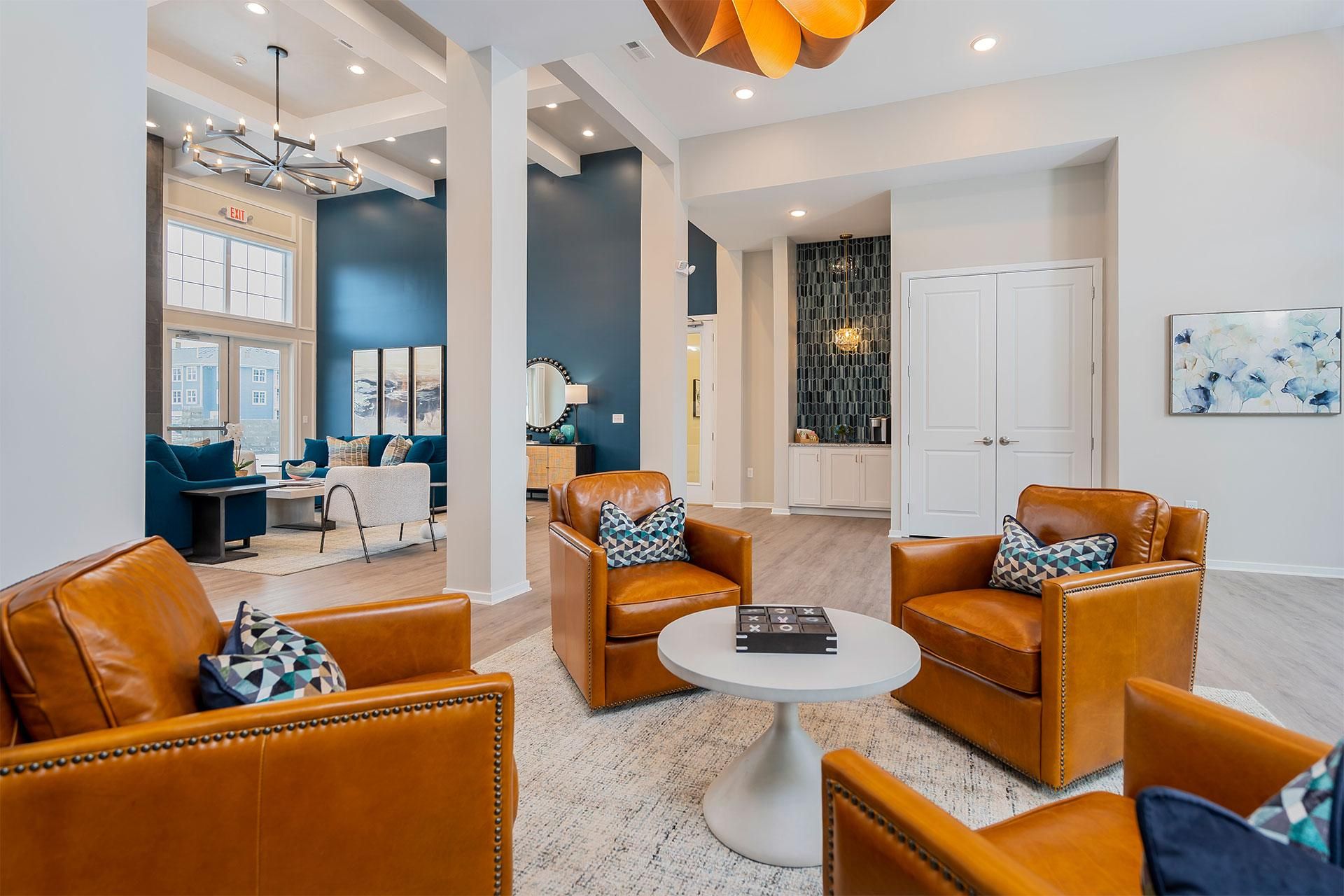 Resident lounge with brown leather chairs and a white coffee table.