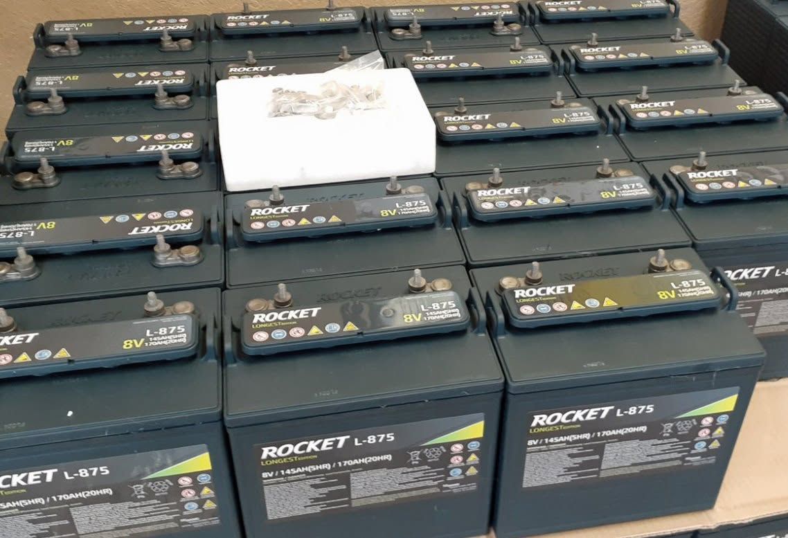 Rows of black product boxes stacked with one white box on top