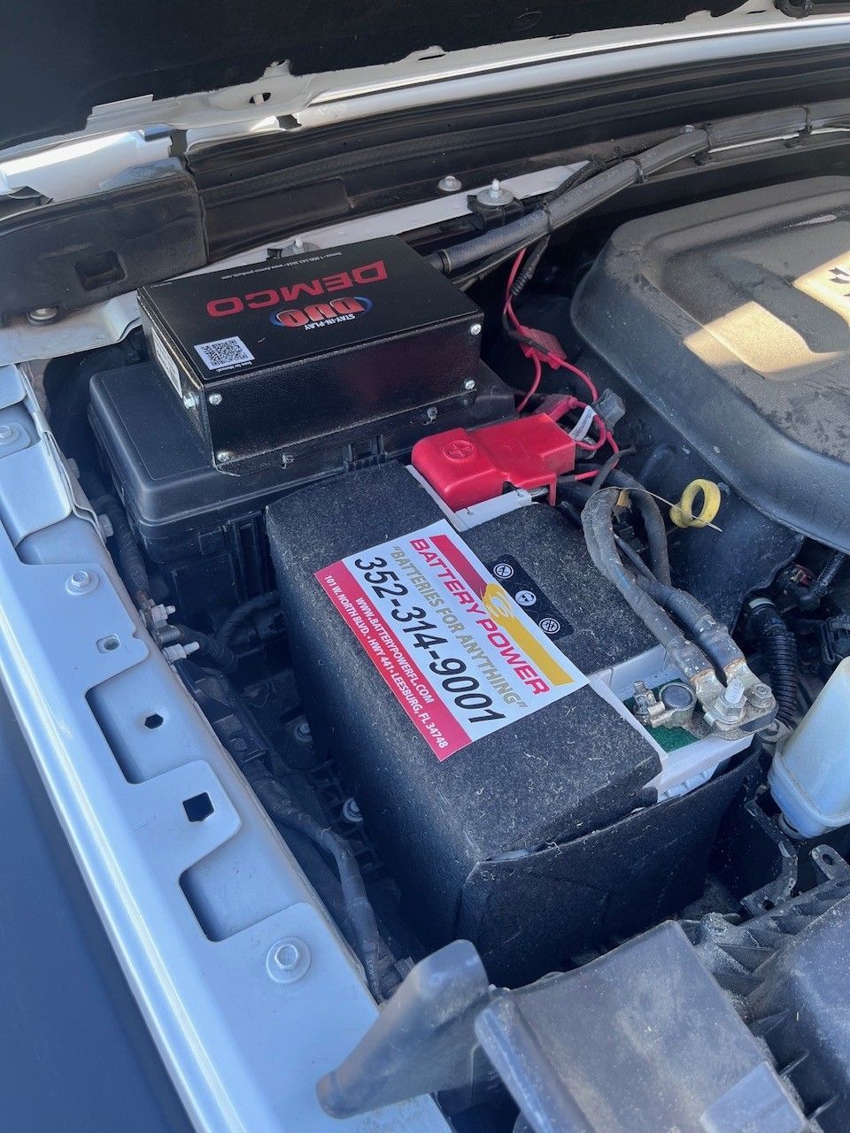 Black JMC 3000 air compressor with hose and yellow label on a store shelf