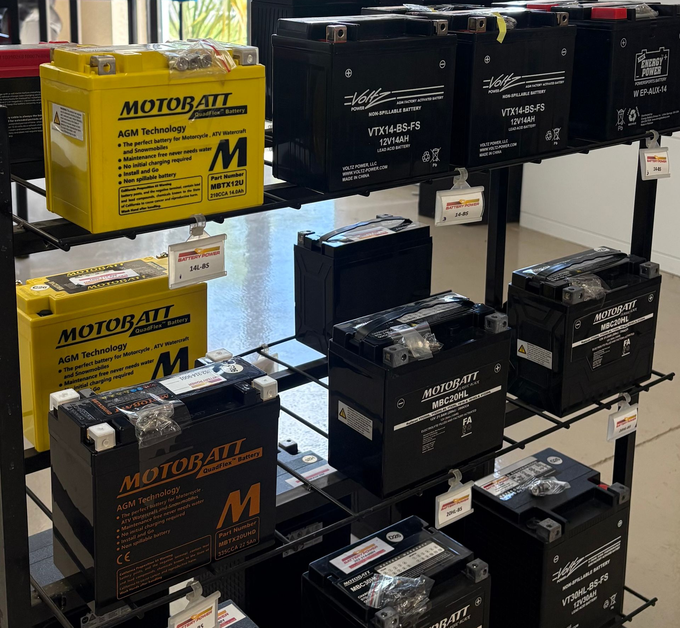Motorcycle shop display with boxed products under a red “MOTORCYCLE” sign