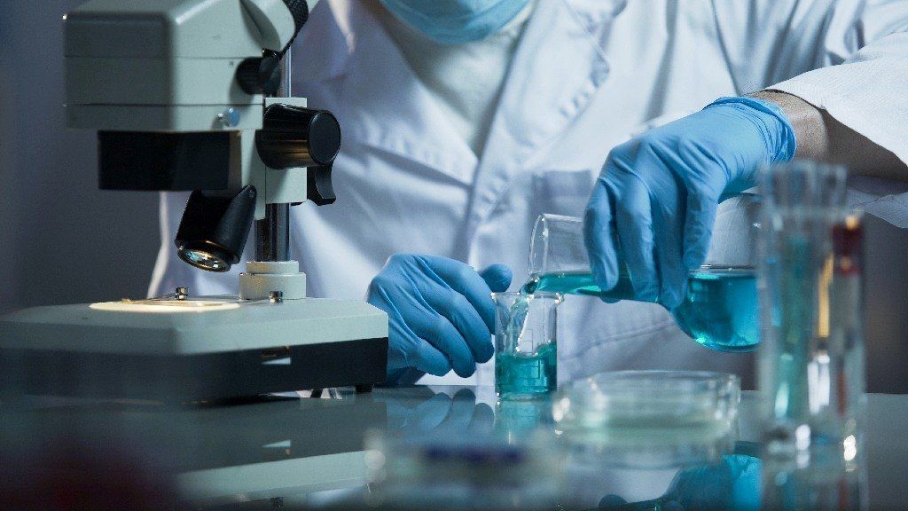 researcher with glass laboratory chemical test Leysons