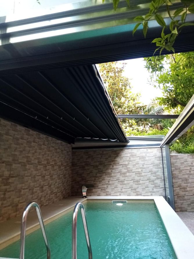 Una piscina con scale che vi conducono sotto una tettoia