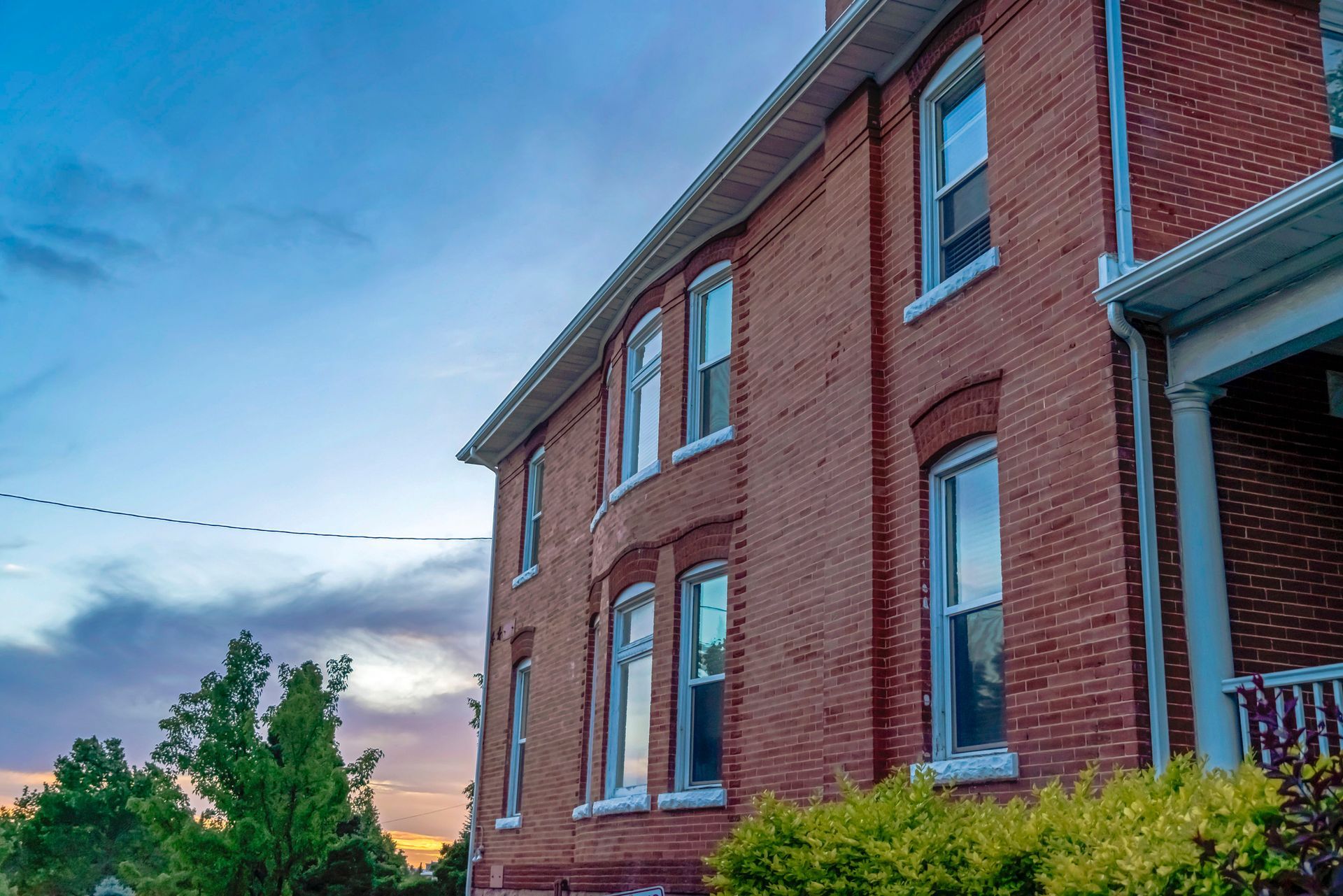 Red brick house at dusk. Red brick house at dusk.