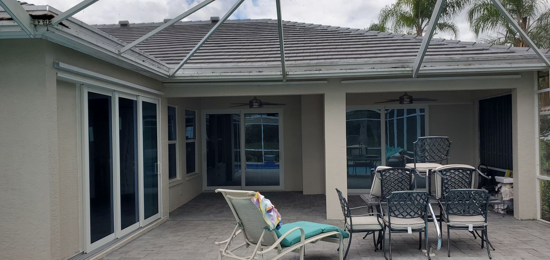 Patio with outdoor furniture, sliding doors, and a pool view.