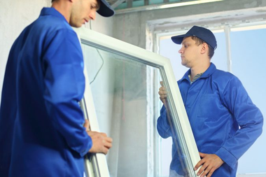 Window installers carrying a replacement window