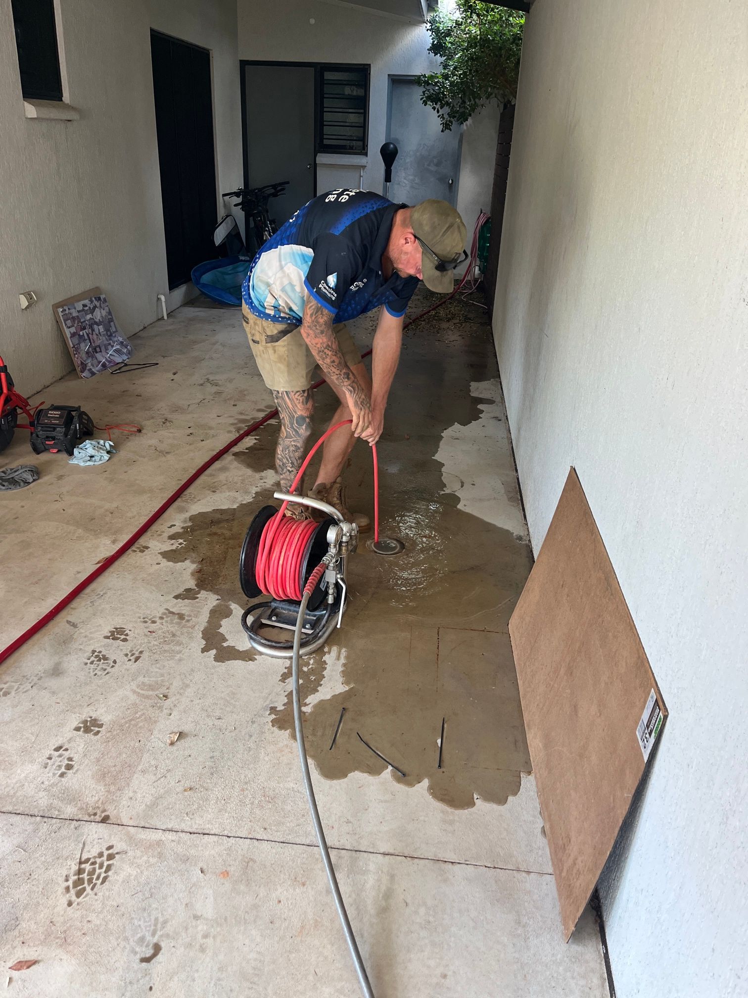 Plumbing tradie cutting concrete