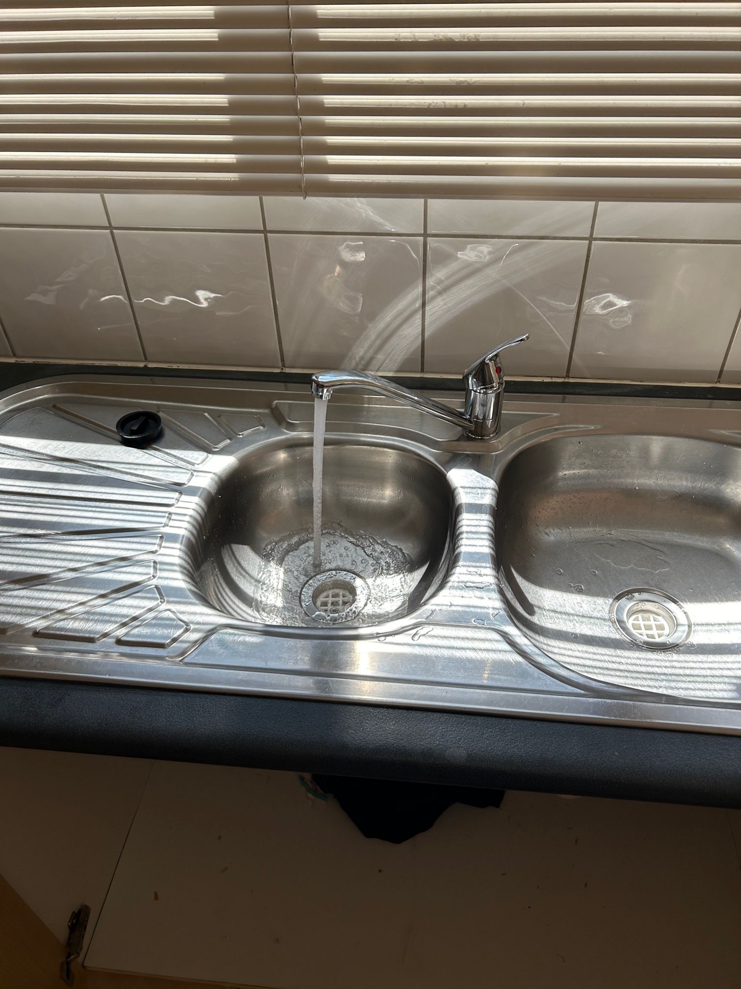 Running tap over kitchen sink