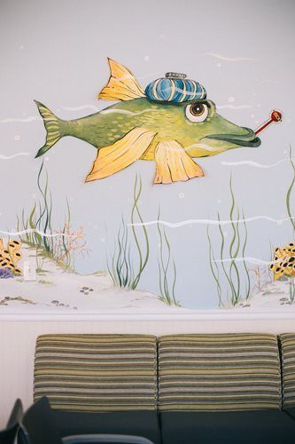 Cartoon fish with a cold, wearing a blue ice pack, wall mural.