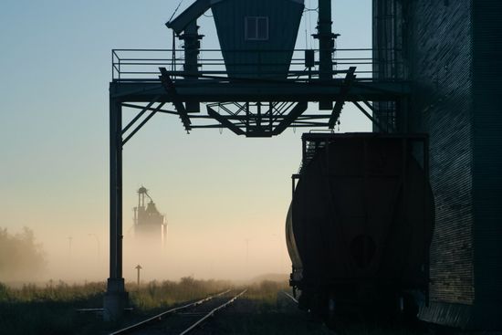 A train is going down the tracks in the fog