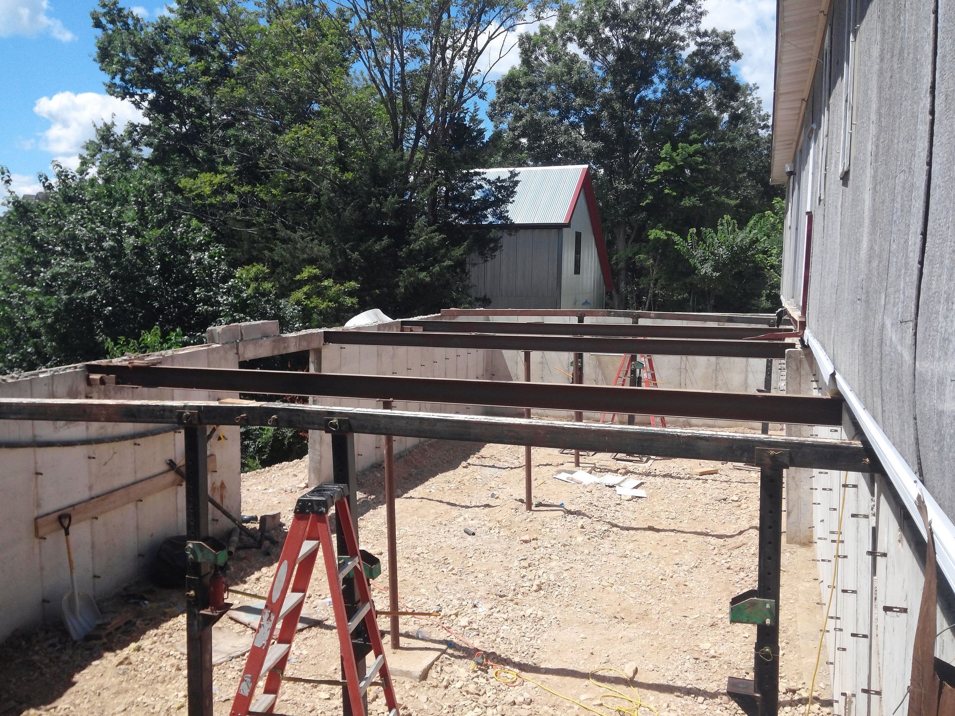 A Ladder Is Sitting in Front of A Building Under Construction | Winfield, MO | Excalibur Manufactured Housing Services LLC A Ladder Is Sitting in Front of A Building Under Construction | Winfield, MO | Excalibur Manufactured Housing Services LLC
