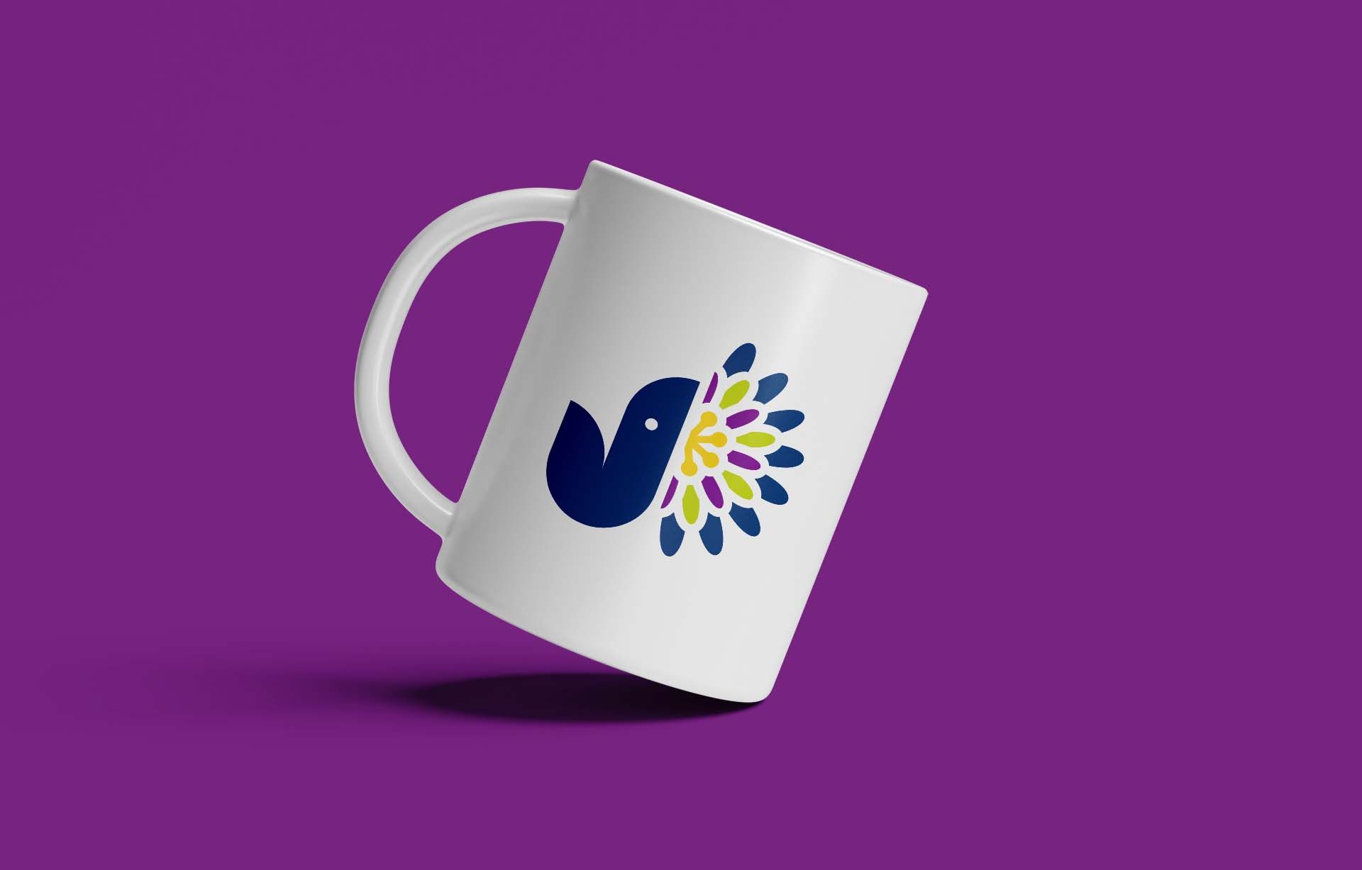 White mug with a blue logo on a purple background, tilted and casting a shadow