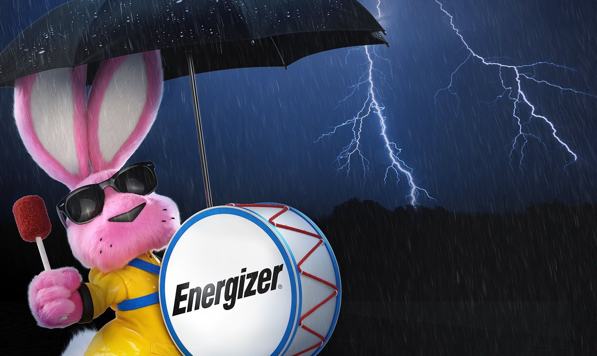 A pink energizer bunny holding an umbrella and a drum