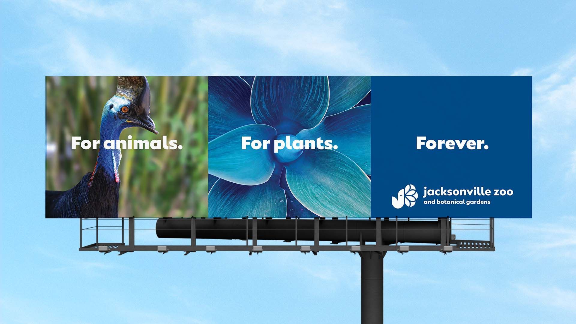 Billboard reading “For animals. For plants. Forever.” with Jacksonville Zoo and Gardens logo on blue sky background