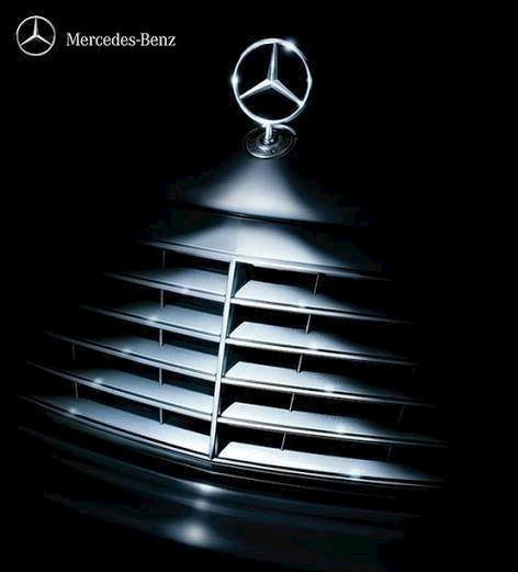 A close up of a mercedes benz logo on a black background