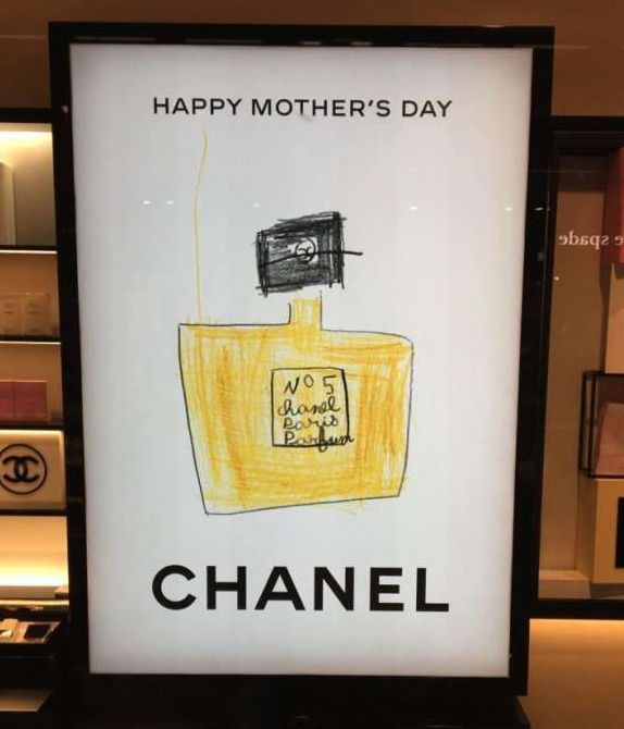 A chanel sign with a drawing of a perfume bottle