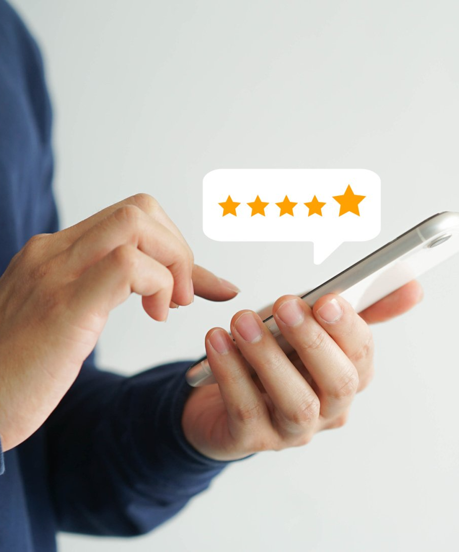 A person is holding a cell phone with a speech bubble that says five stars