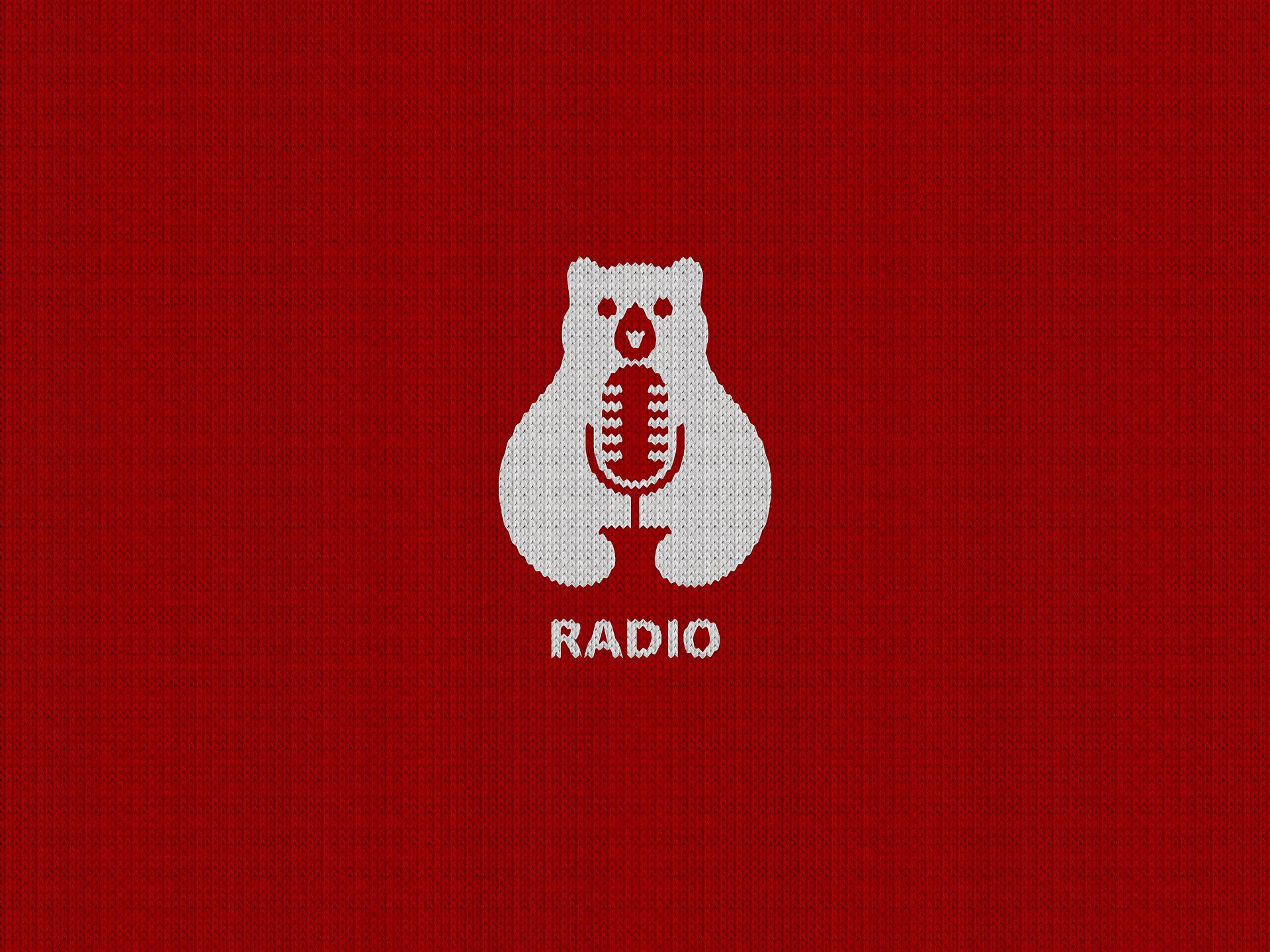 A polar bear is holding a microphone on a red background.