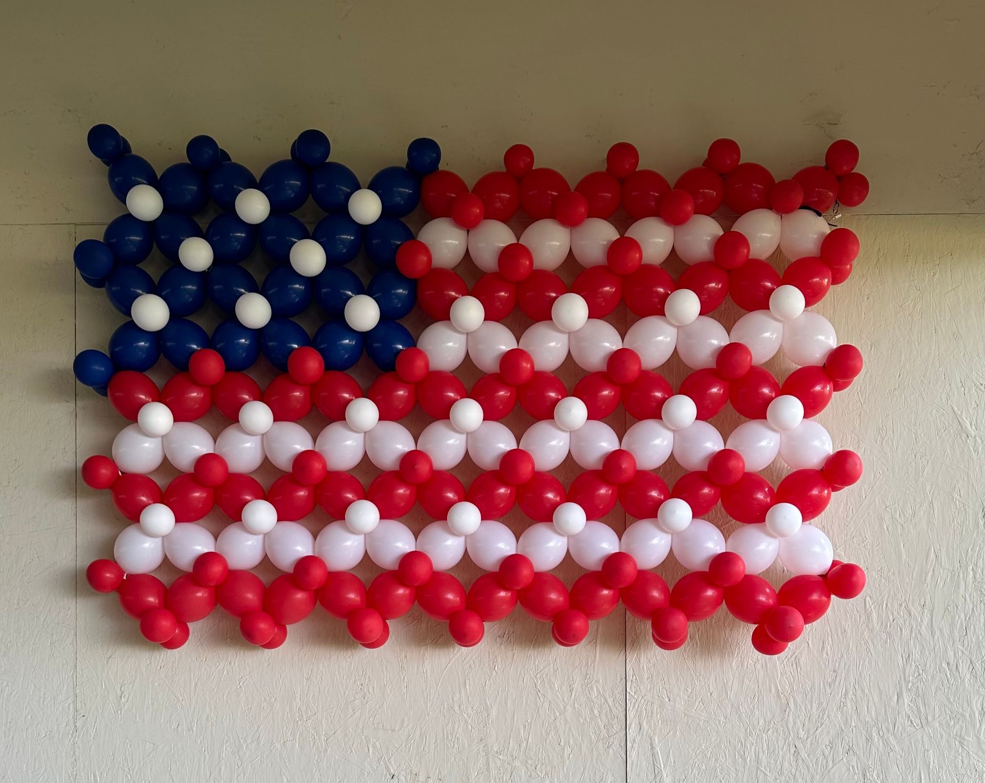 An american flag made of red white and blue balloons