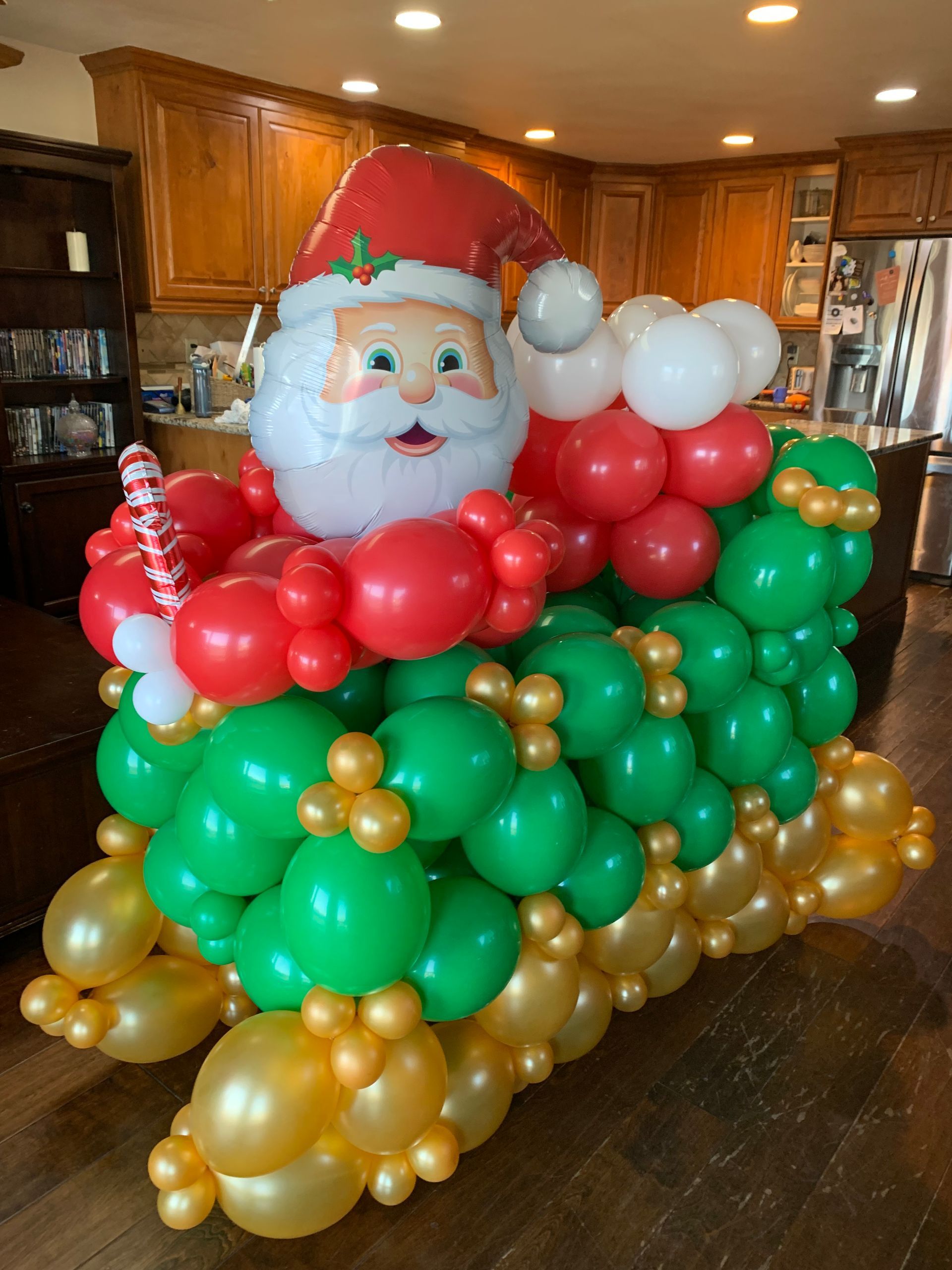 A santa claus sleigh made out of balloons in a kitchen.