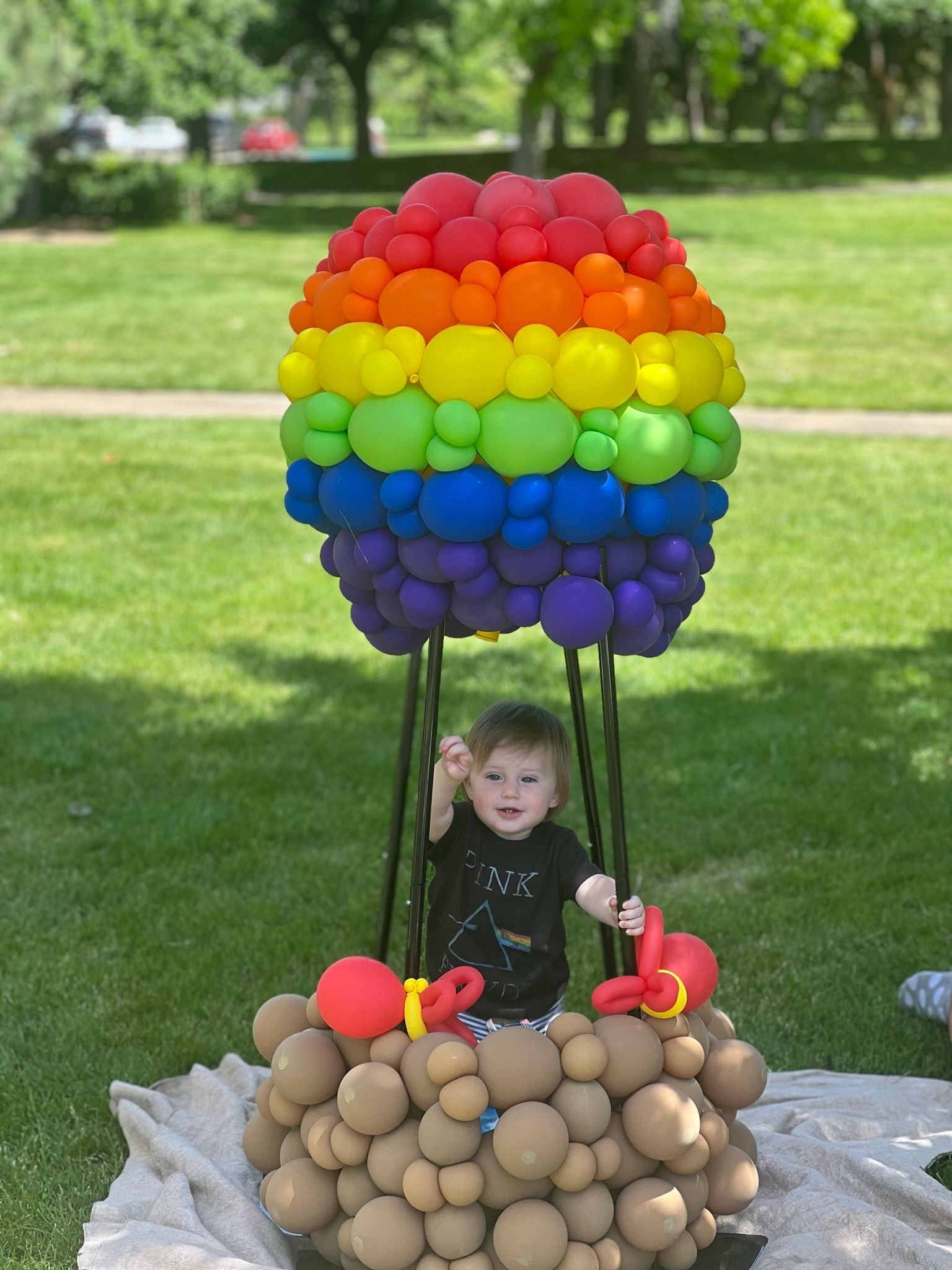 A little boy is sitting in a hot air balloon made of potatoes.