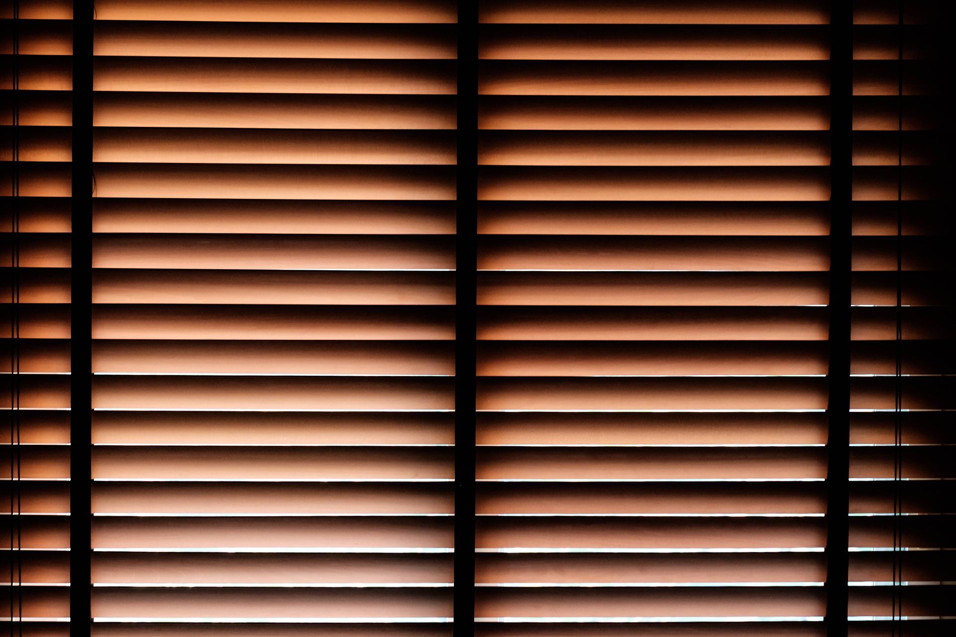 A gorgeous set of wood blinds with light peeking through at Fabric Works near Spokane ,Washington(WA