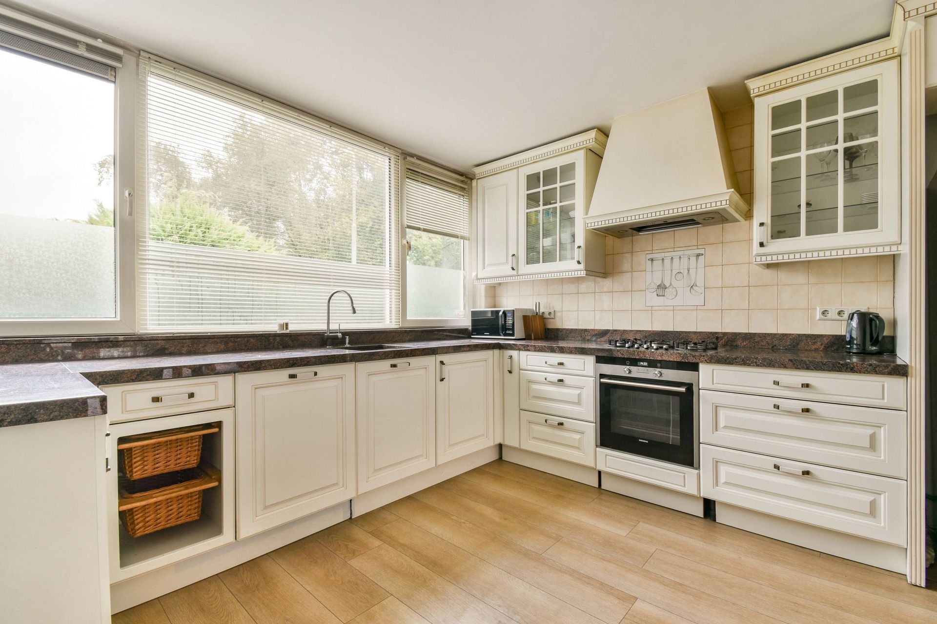 A kitchen with three windows and three sets of window blinds at Fabric Works near Spokane ,Washingto