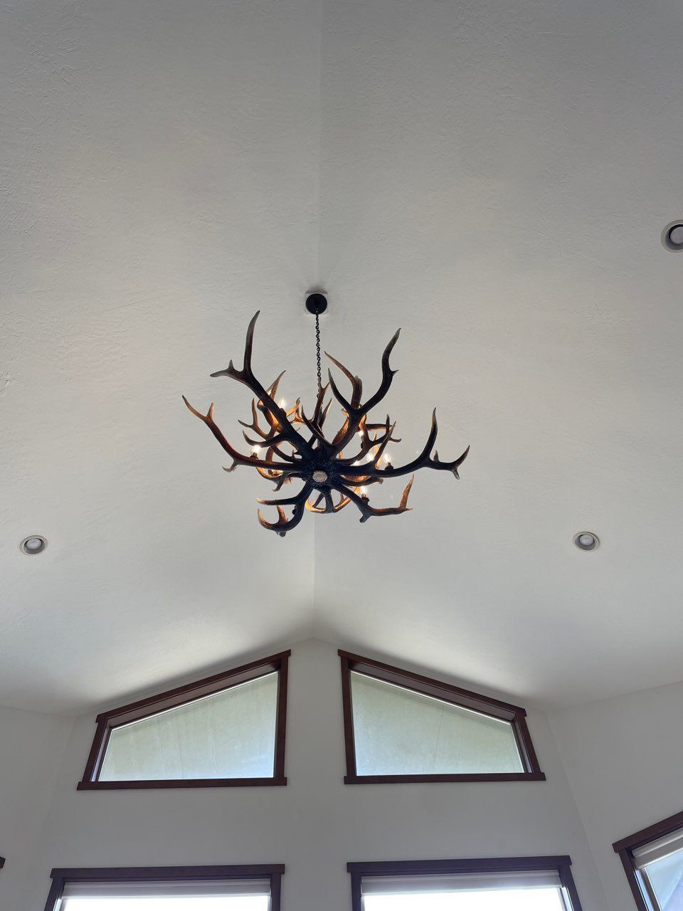A chandelier made of antlers hangs from the ceiling
