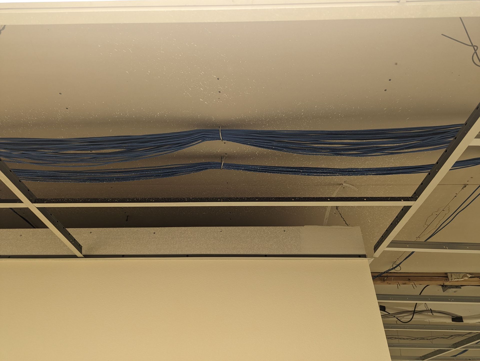 A ceiling with a lot of wires hanging from it