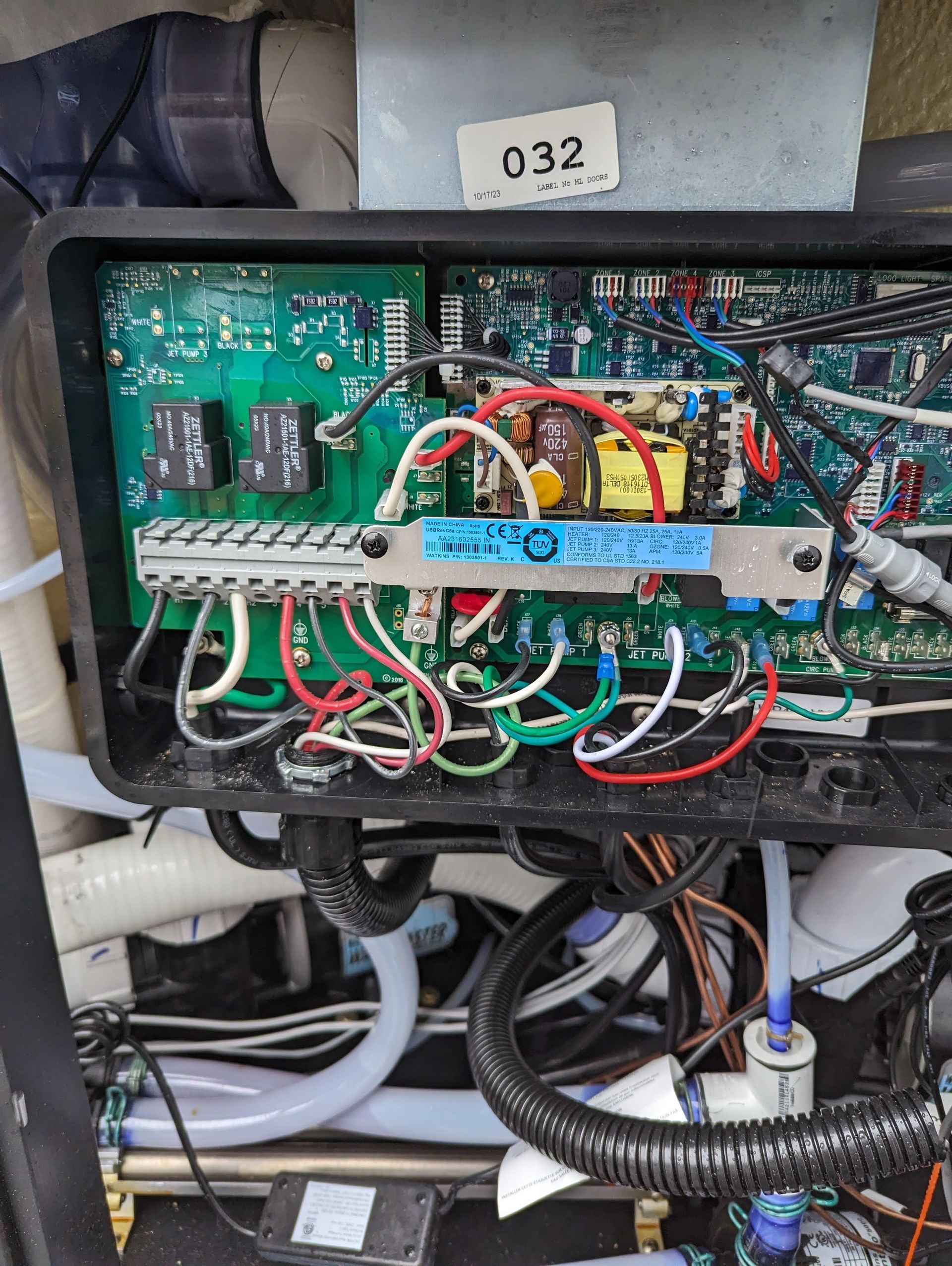 The inside of a hot tub with a lot of wires coming out of it.