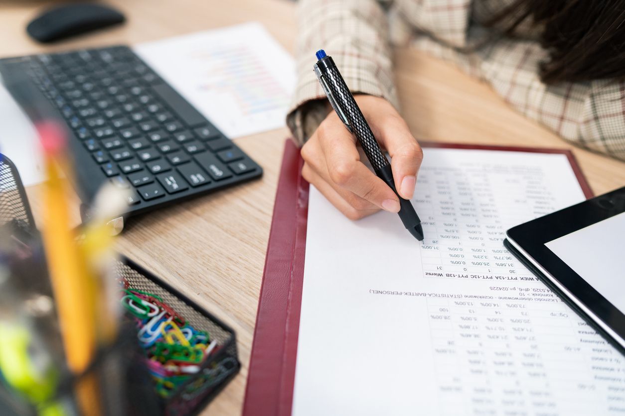 company's calculations, an office accountant sits at the desk filling