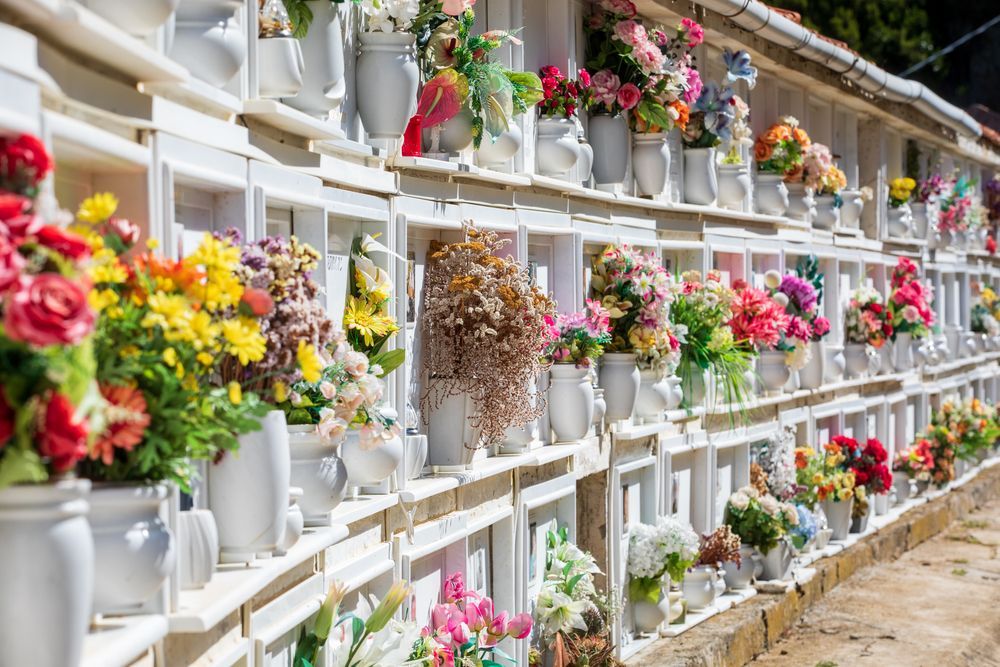 A Cemetery Filled With Lots of Vases With Flowers — Hutchinson Family Funerals In Taree, NSW