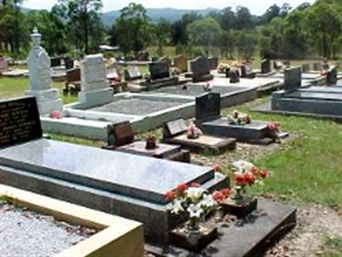 A Cemetery With a Lot of Graves and Flowers — Hutchinson Family Funerals In Taree, NSW