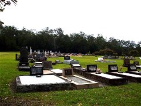 A Cemetery With Lots of Graves and Trees in the Background — Hutchinson Family Funerals In Taree, NSW