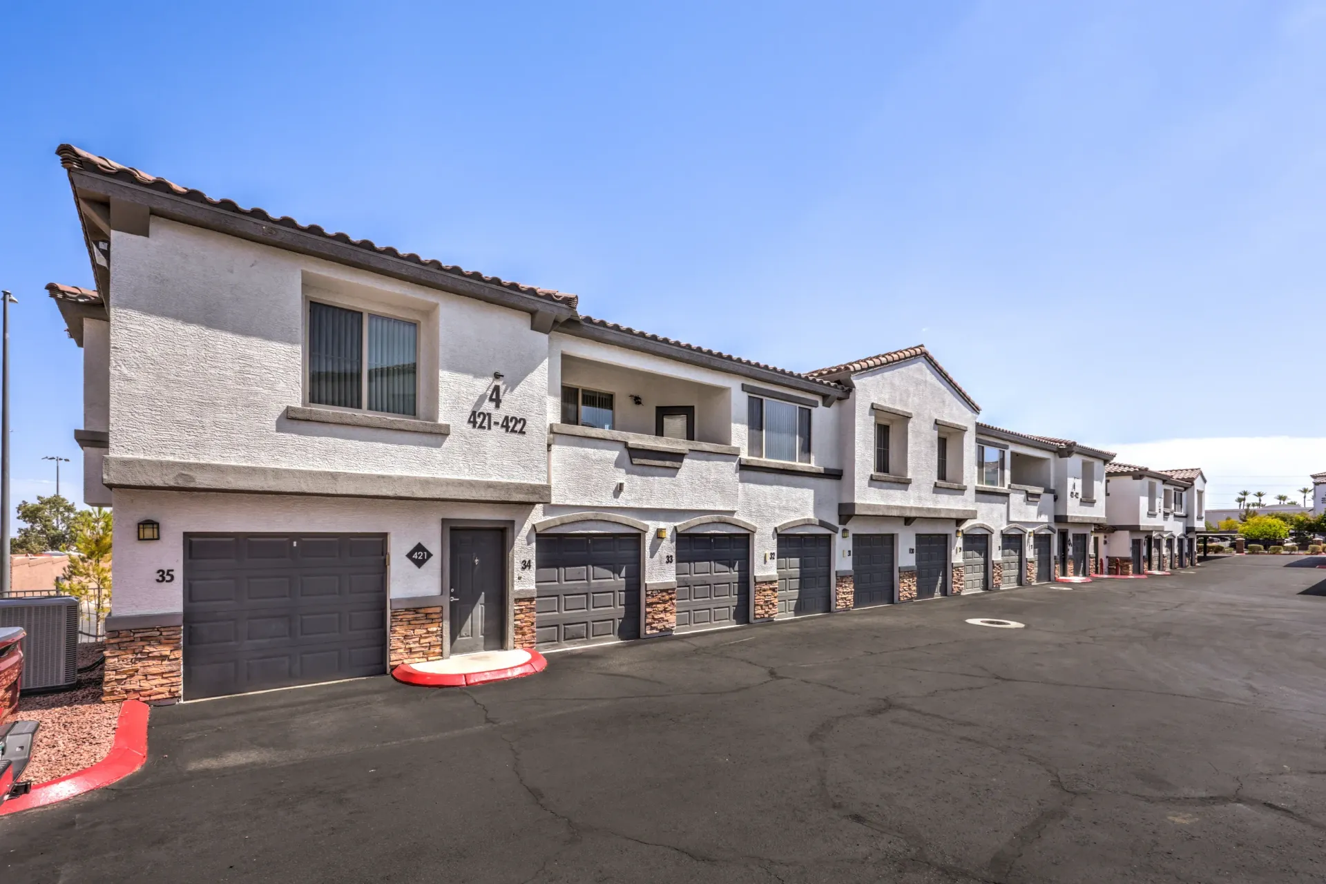 Exterior view of apartment buildings with garages and balconies at Cornerstone Park in Henderson, NV.