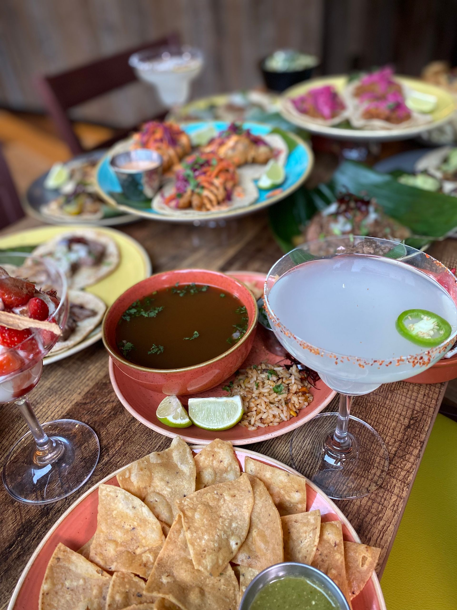 A table topped with plates of food and drinks.