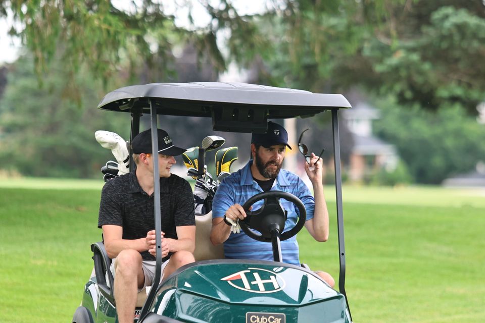 A group of people are posing for a picture on a golf course.