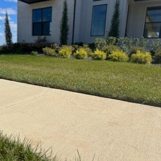 freshly dried sidewalk in front of new construction
