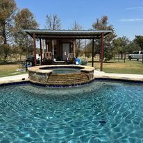 A large swimming pool with a gazebo in the background.